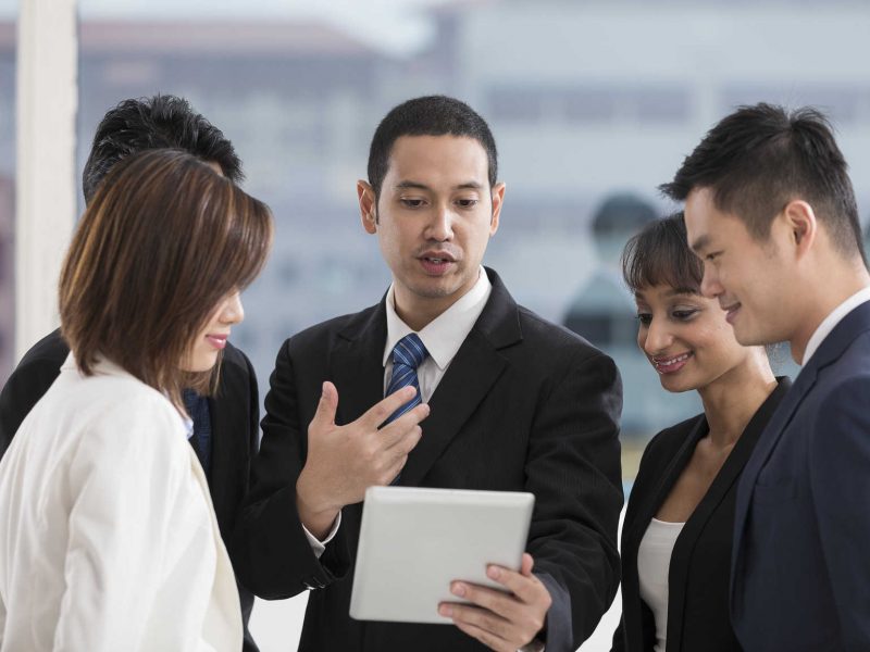 A group of muliethnic Business people using a digital tablet in the office.